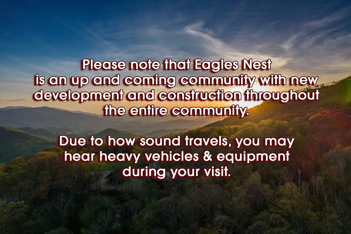 A breathtaking view of a mountain range at sunset, framed by lush greenery. The scene suggests a tranquil yet evolving mountain community, with hints of both nature and subtle signs of neighborhood development.